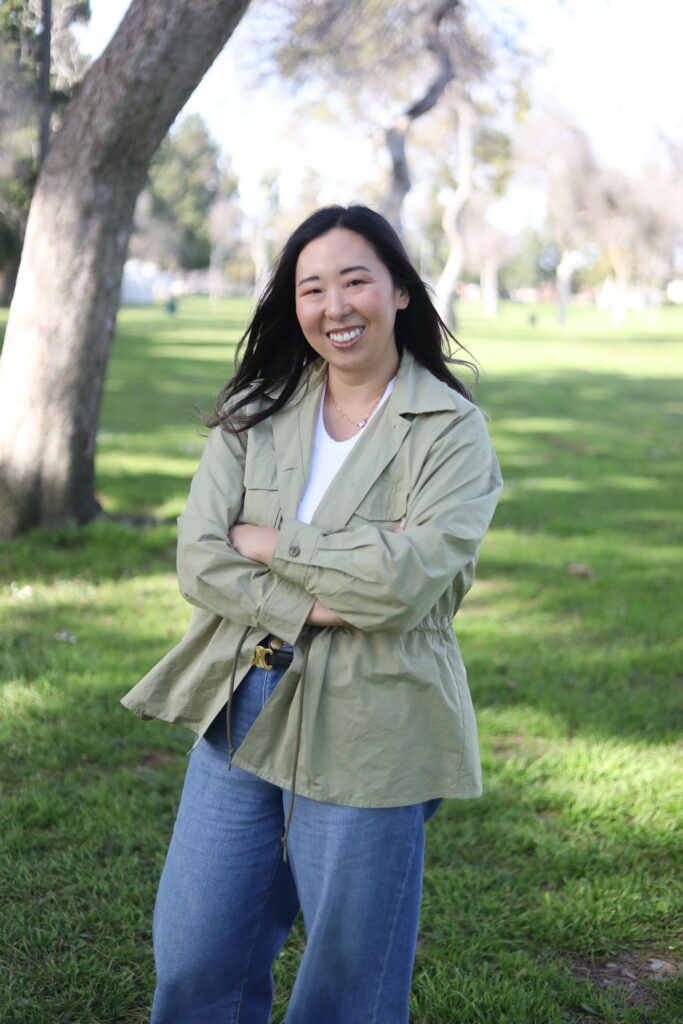 Yuki standing outside wearing a green jacket