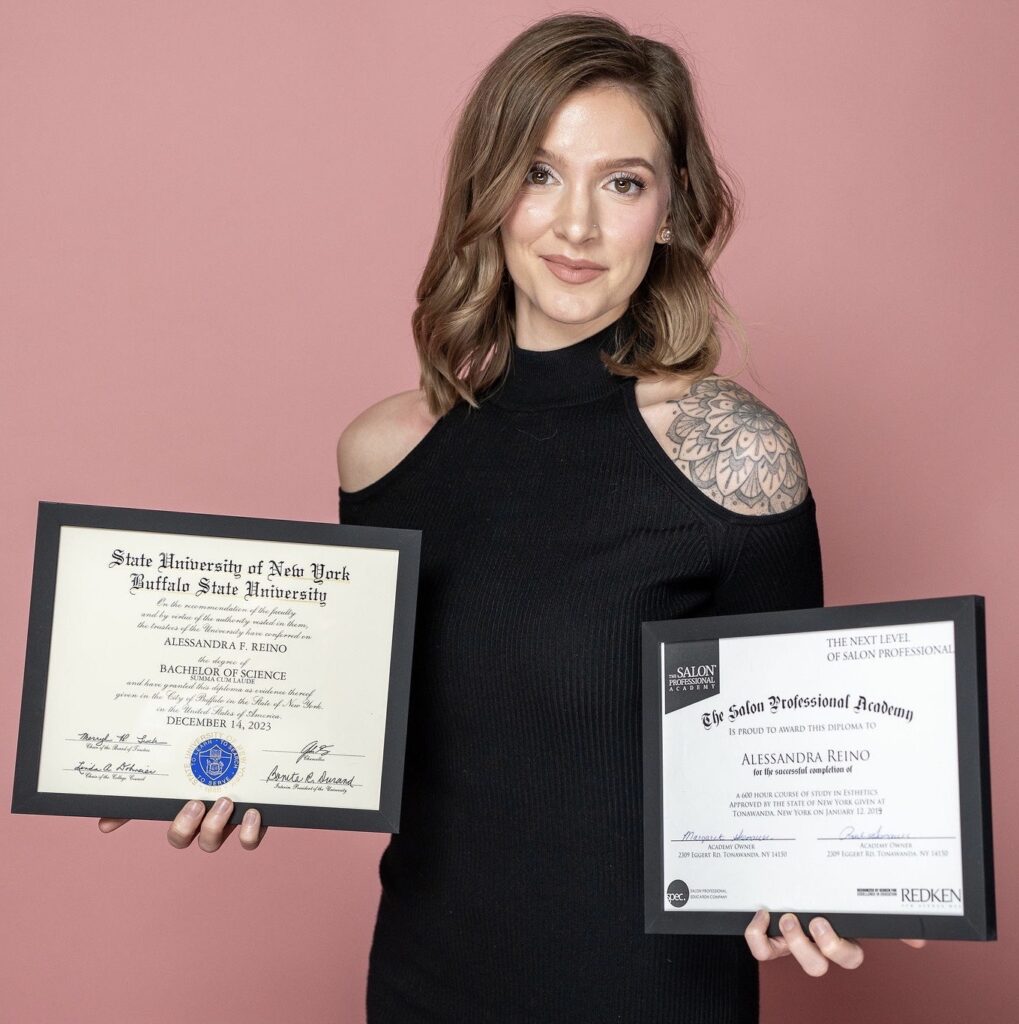 Alie Reino holding her degrees